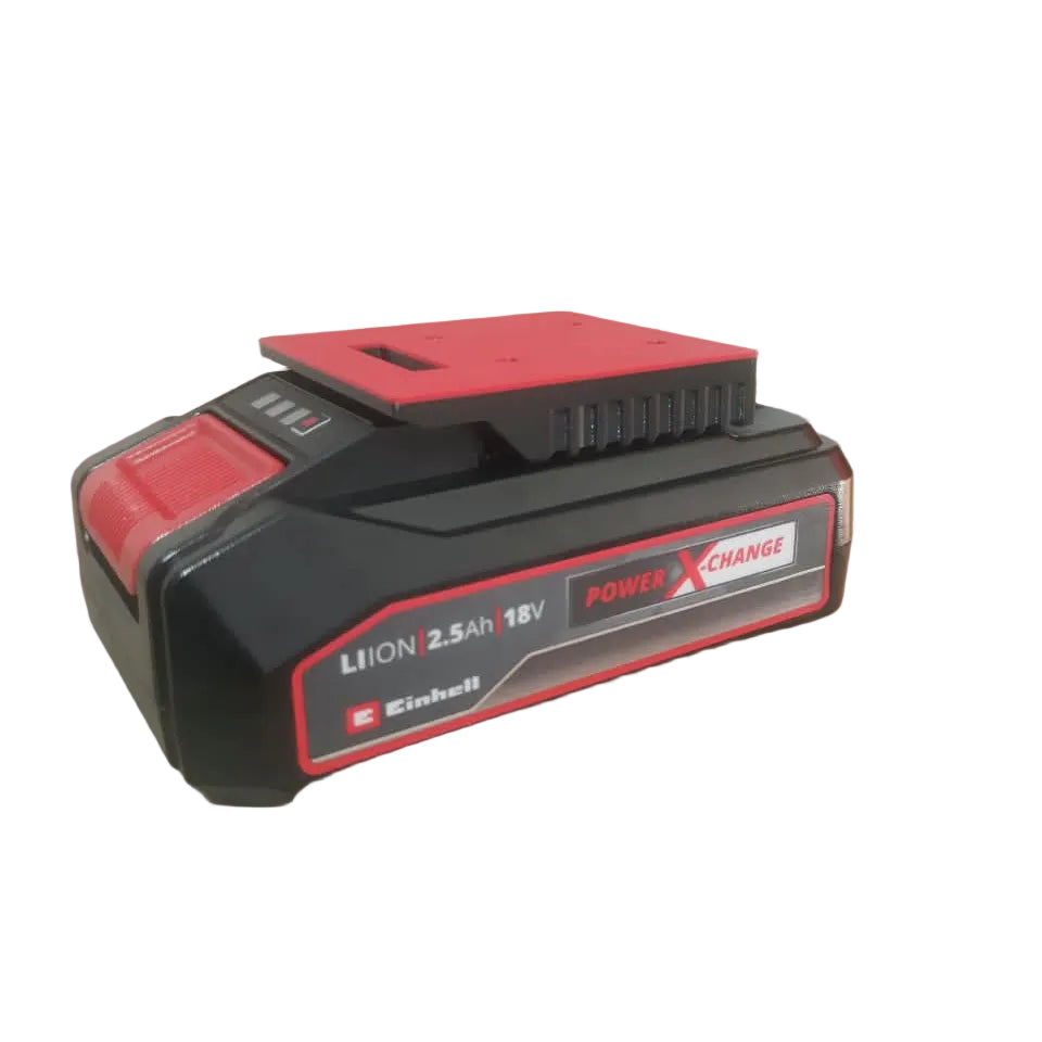 A black and red Einhell cordless battery pack labeled 'LION 2.5Ah 18V POWER X CHANGE' resting on brown cardboard packaging.