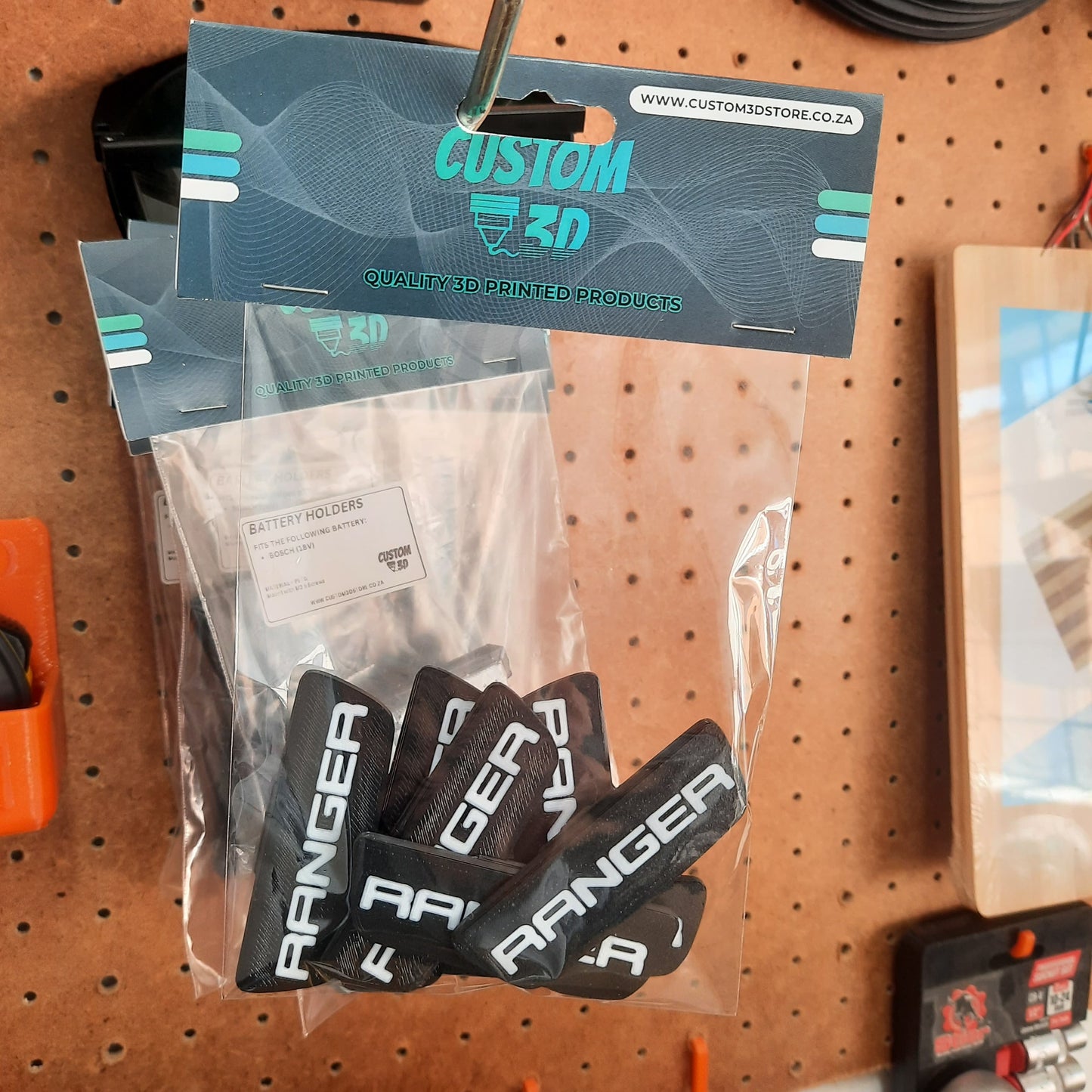 Packaged 'Ranger' products under a 'Custom 3D' label on a pegboard.