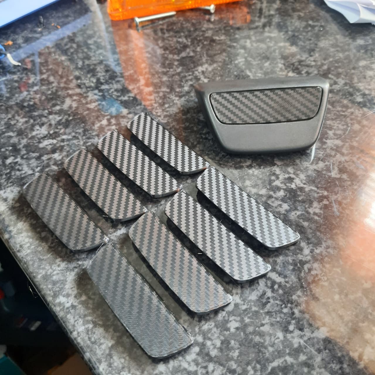 Plain Black End Caps with a Carbon Fiber Pattern for Ford Ranger or BT-50 on a table
