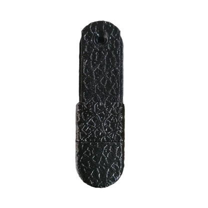 Black textured object on a wooden surface