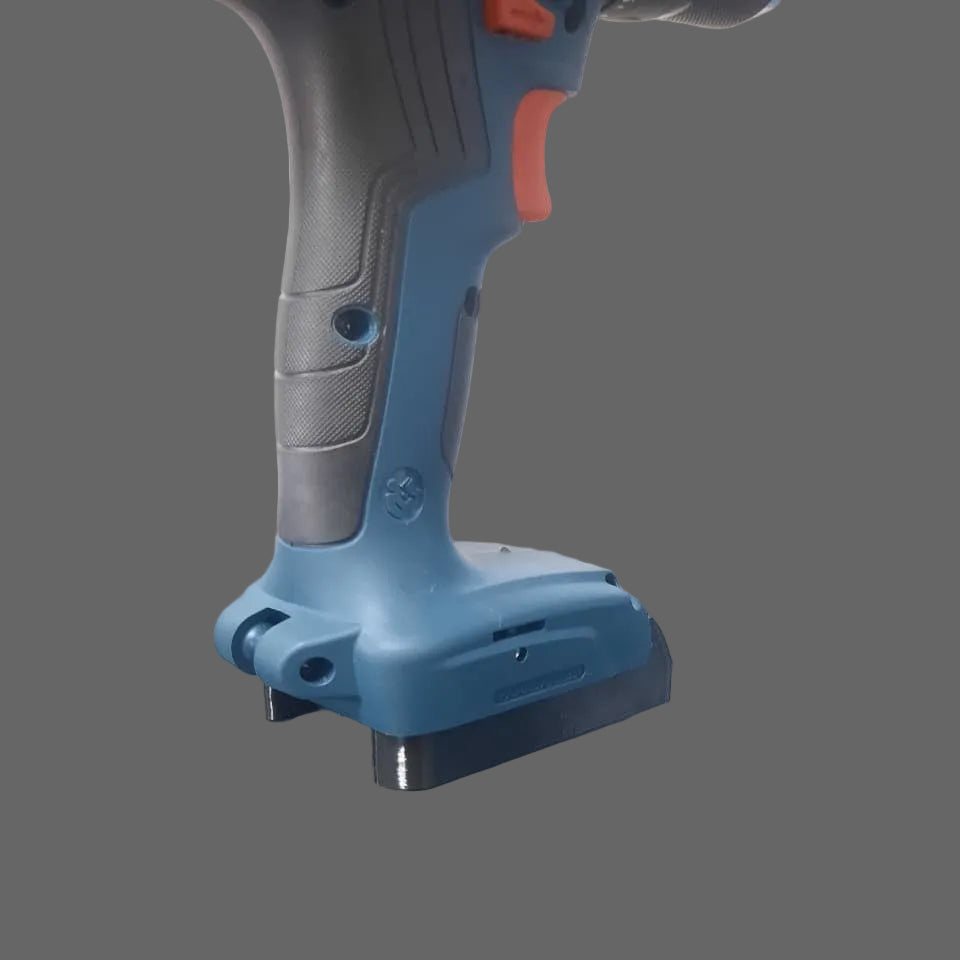 Blue cordless drill on a reflective surface with a white background