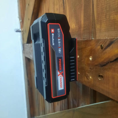A black and red Einhell Lithium 2.0Ah battery pack resting on a rustic wooden surface.