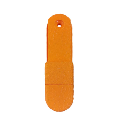 Orange plastic tool on a wooden surface