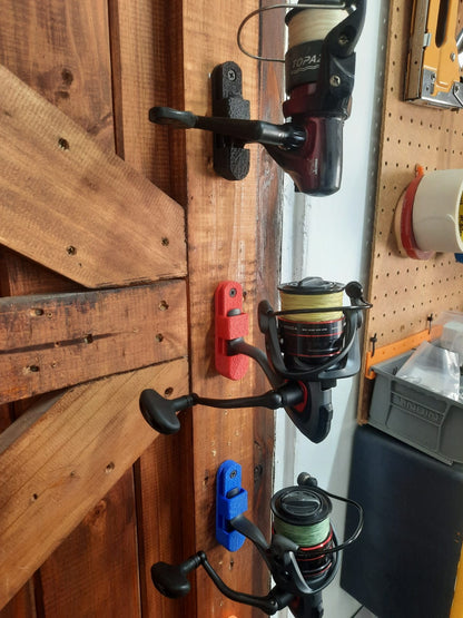 Fishing reels attached to a wooden door.