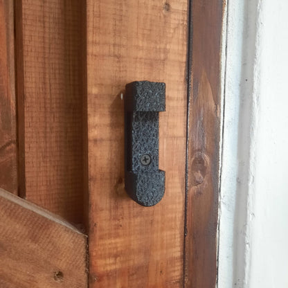 Wooden door with a black fishing reel mount