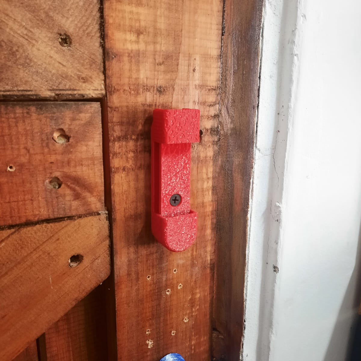 Red fishing mount on a wooden surface with a white background