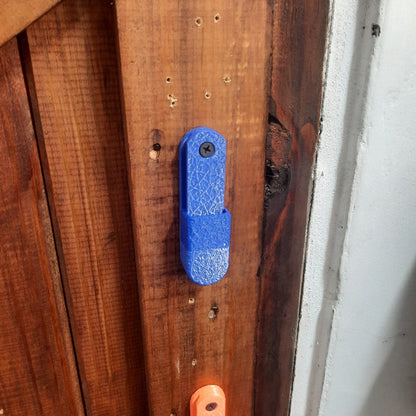 Blue and orange tool on a wooden surface