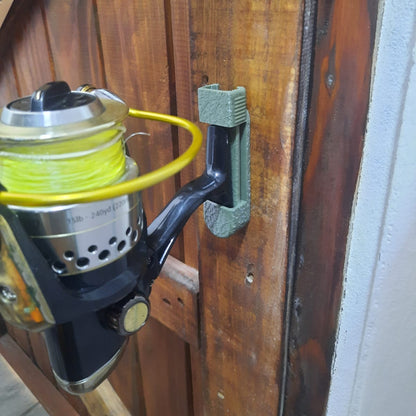 Fishing reel attached to a wooden door