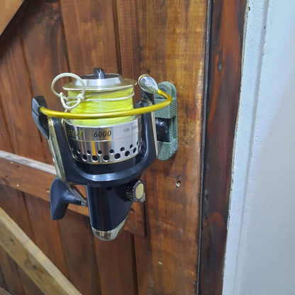 Fishing reel with yellow line on a wooden surface