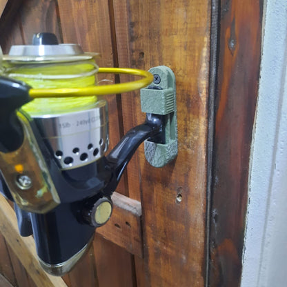 Fishing reel attached to a wooden surface