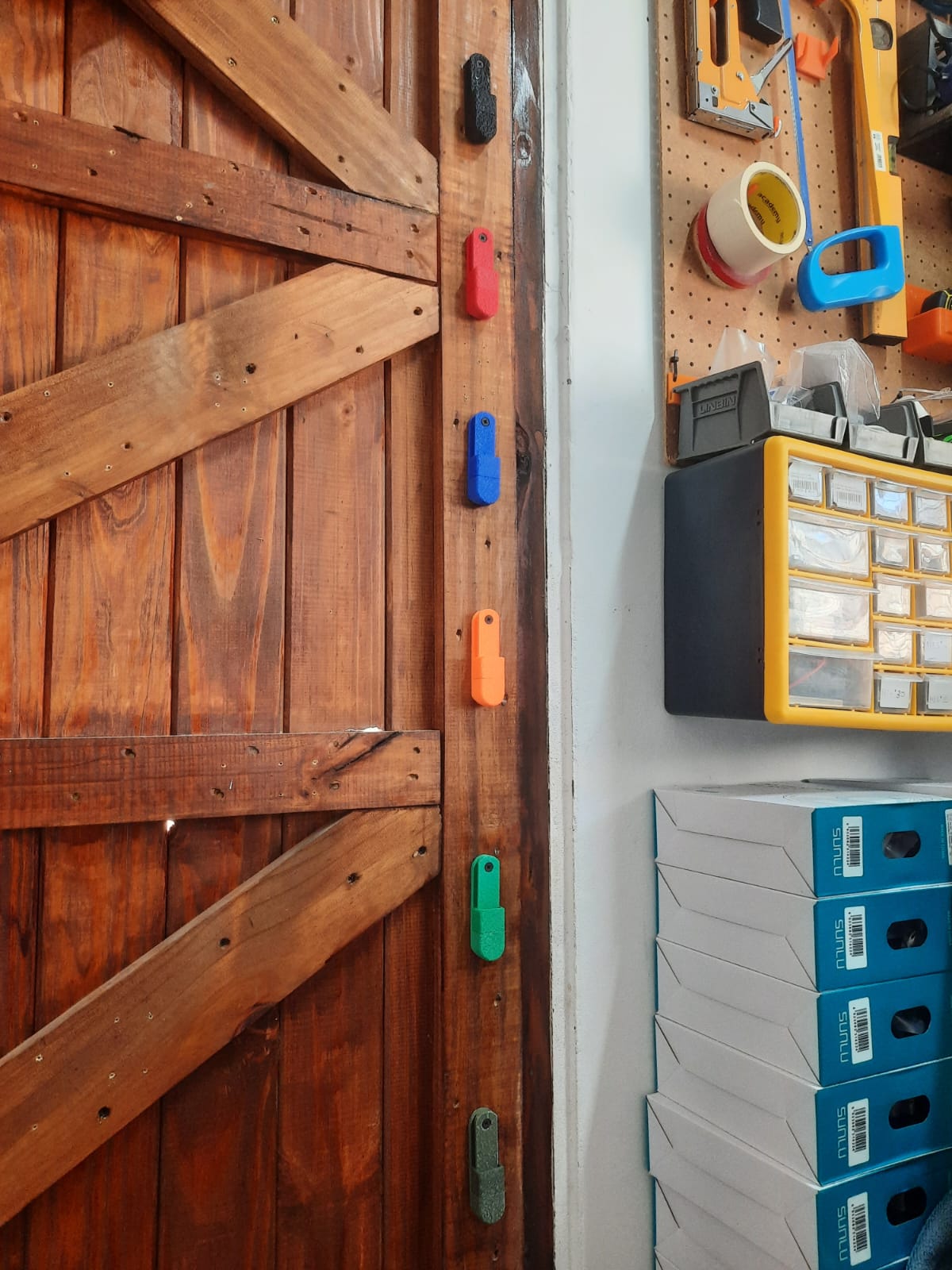 Wooden door with various colur fishing reel mounts