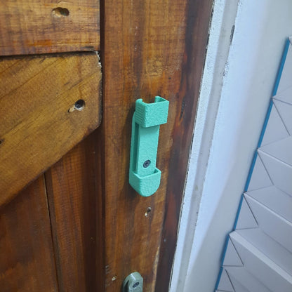 Wooden door with a green mount and white wall in the background