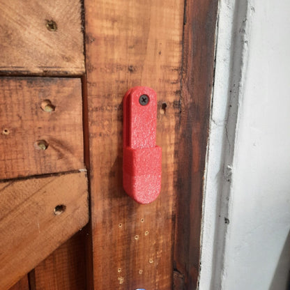 Red fishing mount on a wooden surface with a white background