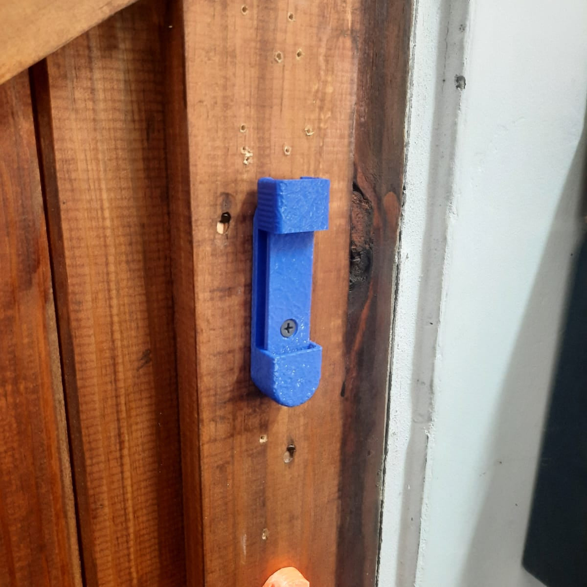 Blue and orange plastic clips on a wooden surface