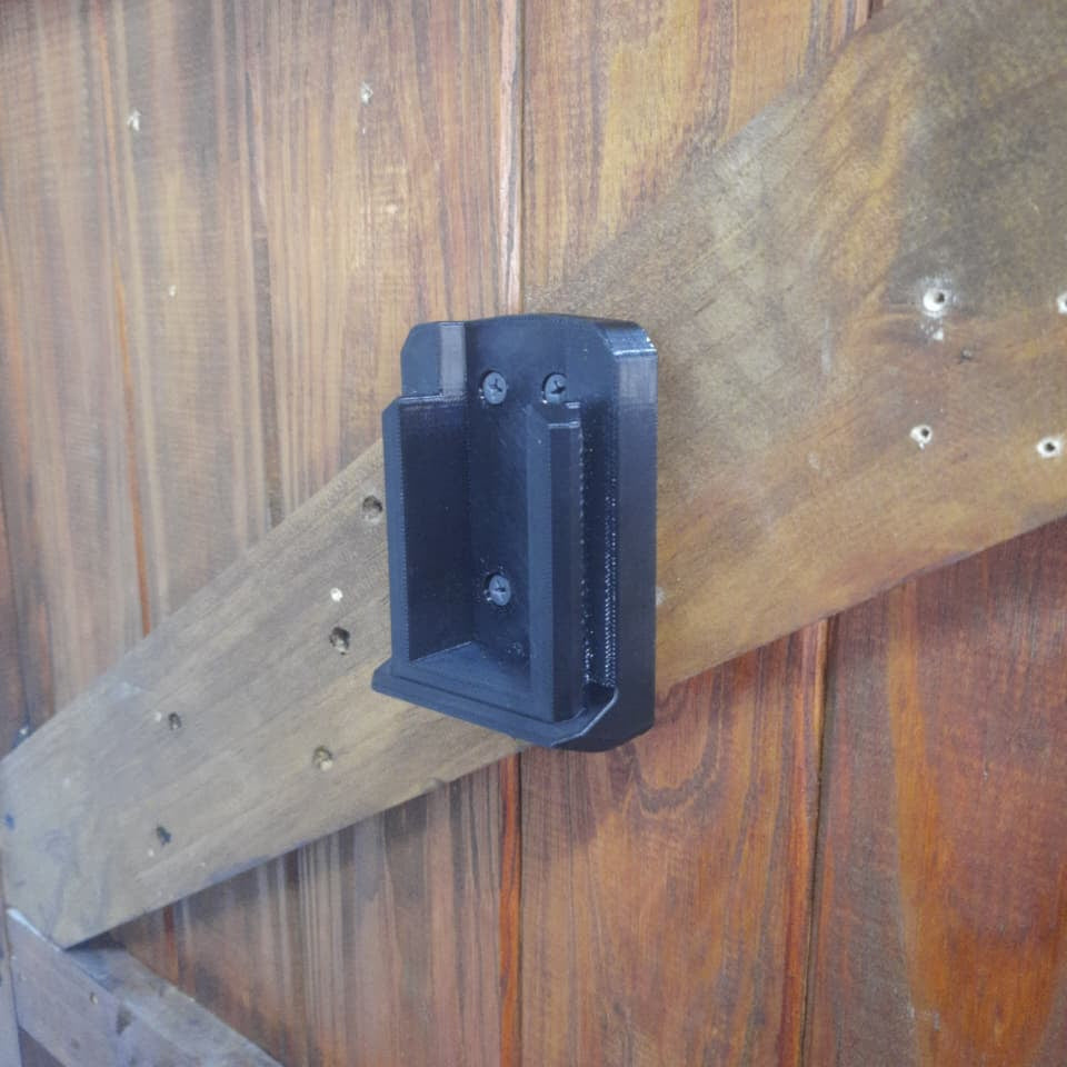 INGCO 42V Tool Mount from an angle mounted on a door