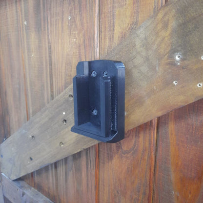 INGCO 42V Tool Mount from an angle mounted on a door